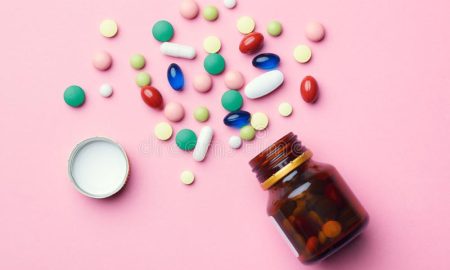 colorful-medicine-pills-capsules-tablets-glass-bottle-pink-background-top-view-flat-lay-colorful-medicine-pills-capsules-147597942